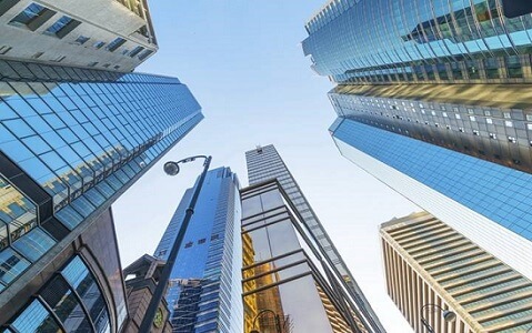 A photo taken between skyscrapers looking to the sky